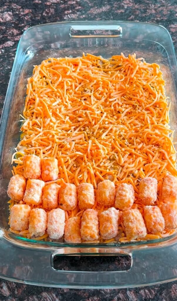 Top with an even layer of tater tots then sprinkle remaining 1 cup cheddar over top.